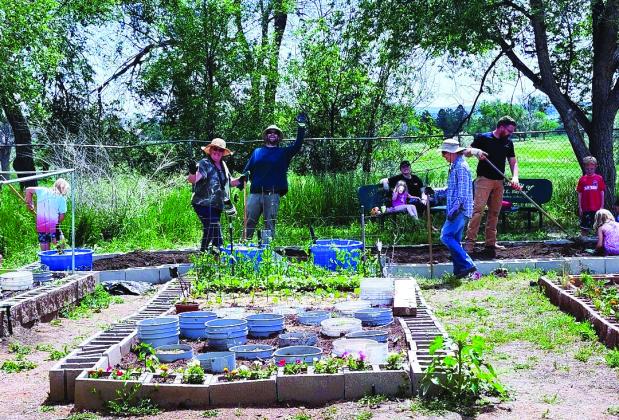 This hard-working group of volunteers built two new beds in the Community Garden on Saturday, June 1. Photo by Shirley Pigg