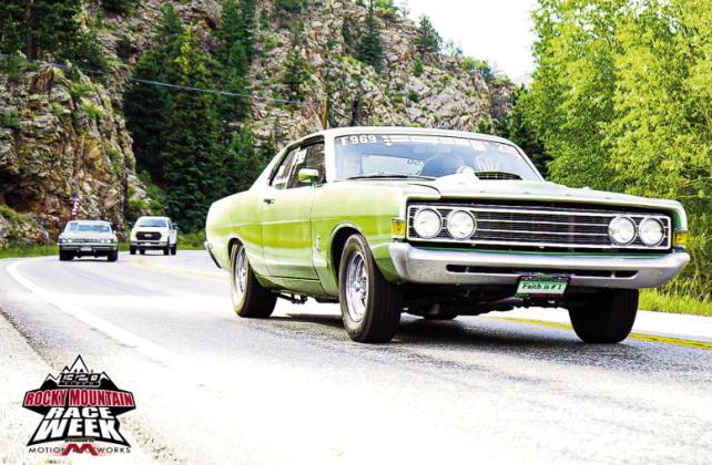 Rocky Mountain Race Week Chaplain and drag racer Randy Peterson and daughter Jessica driving through Estes park in the 2022 event. Courtesy Photo