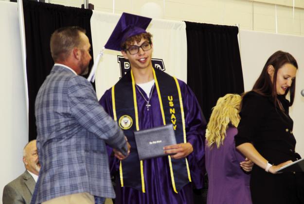2023 Rye High School Graduate Elijah Perez Jr is congratulated by Pueblo Public School District Board of Director John Christianson. Perez has made a committment to the United States Navy, and will report for duty in one month. Photo by Terry Kraus