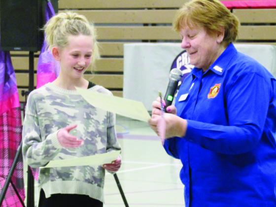 Toni Leibnow, VFW Post #7305 (R), presents Patriot’s Pen award to Molly Balenseifen at the Craver Middle School ceremony. Photo by Shirley Pigg