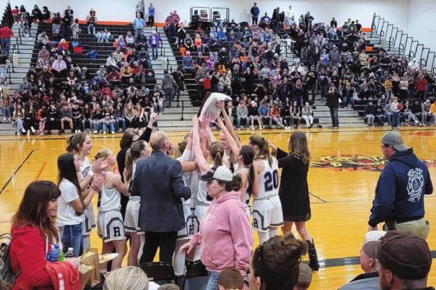 The Rye High School Girls basketball team and Head Coach Kermit Spencer celebrate a District Championship and a perfect 22-0 record heading into Regional Action. Rye downed Hoehne 33-24 in their third meeting with the Santa Fe League Farmers. They also downed Holly 69-30 in first round district action. Courtesy Photo