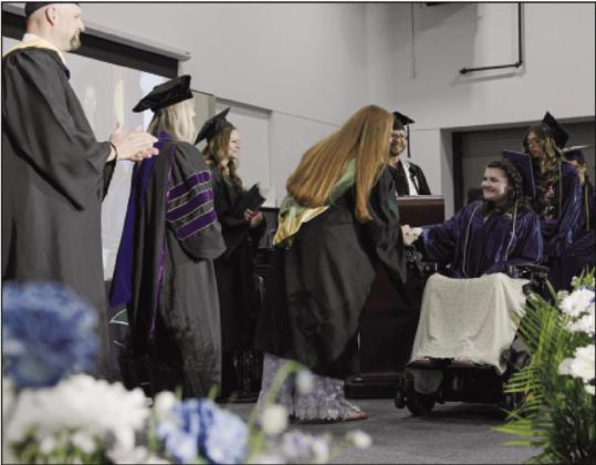 A GOAL graduate receives her high school diploma from a teary-eyed assistant principal. She was one of 1,313 2024 graduates. Courtesy Photo