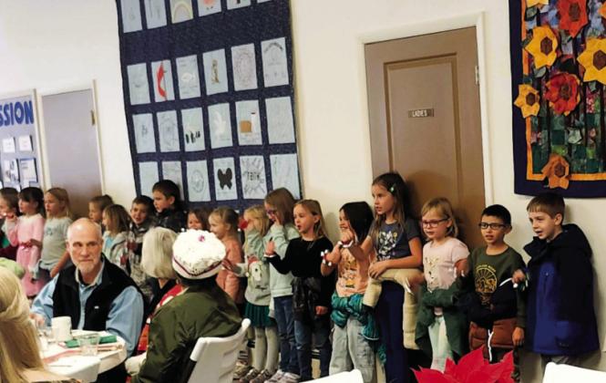 Students of the Rye Elementary School thrilled the luncheon attendees by singing Christmas songs and playing the bells. Photo by Shirley Pigg