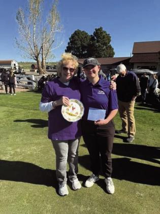 Ann Bush, the mother of Madeline Mellers, presents a check and memorial plate to Emma Garcia, the first recipient of the annual Madeline Mellers Scholarship during the Madeline Mellers Memorial Golf Tournament