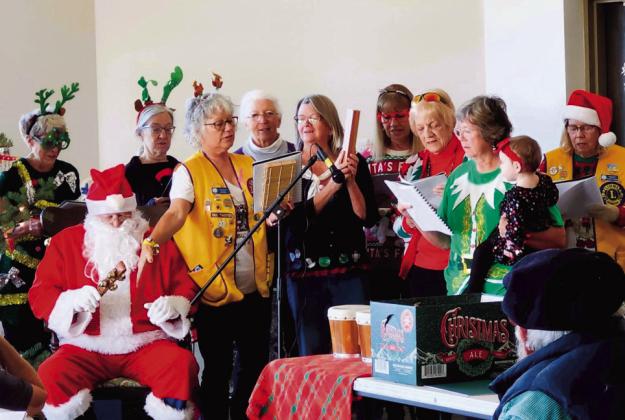 VFC Volunteers, Lions Club members, and Santa Claus all joined voices to create a great and happy sing-along. Photo by Shirley Pigg