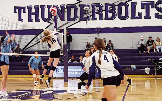 Rye's #16 Hayley Newitt jumps high to hit the ball over for a score against Trinidad on Friday