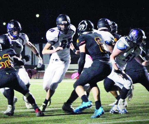 Jared Betz #65 leads a Thunderbolt ball carrier through a hole on the right side of the line during the victory over Banning Lewis. Photo by Karen Rochester