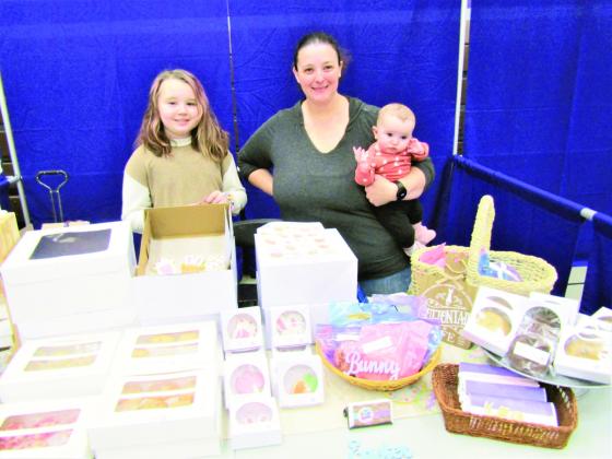 Joanie Campbell Lovell and part of her family proudly displayed treats from her business, Pure Frosting, LLC. Photo by Shirley Pigg