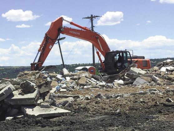 Iron Mountain Demolition working on cleaning up the rubble from demolition at the Circle K Convenience store. Photo by Shirley Pigg