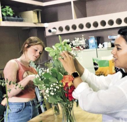 Right: Mountain Blooms employees arrange flowers for the new market. Photos by Shirley Pigg
