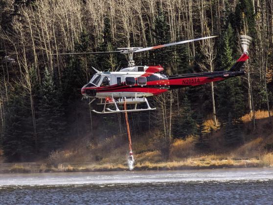 On Sunday helicoptors were seen lifting water from Lake Isabel to fight the blaze northwest of Colorado City and Rye. Photo courtesy of Deb Straub
