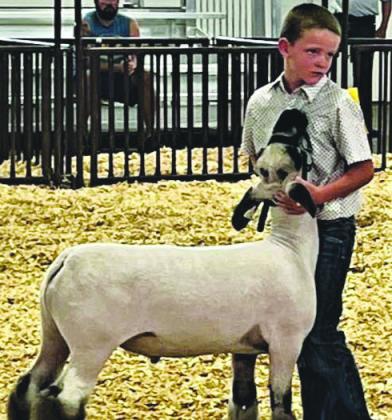 Local 4-H member, Coy Pool, with Lamb Middle Weight Champion at the Pueblo County Fair. Courtesy Photo