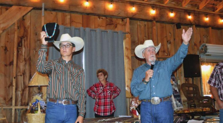 Auctioneer Jake Brunick, Cody Dodge, Cathy Hoffeld volunteer their time for the annual Mountain Aire Festival and Auction. Photo courtesy of Deb Straub
