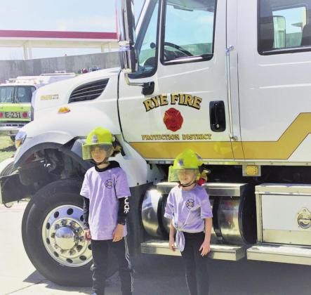 Third grade students Aynaleah Erskine and Nathan Slade honored with Fire Chief for the Day privileges at Rye Fire Protection District Photos by Shirley Pigg