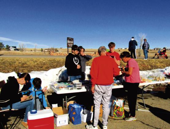 The soccer team boys, coaches, and parents hosted a huge fundraising bake sale at Ace Hardware in December. Photo by Shirley Pigg