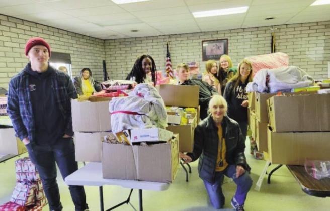 Local Leo’s, with Leo Advisor Lion Paula Maroney, assist in sorting toys for distribution to Greenhorn Valley children. Courtesy Photo