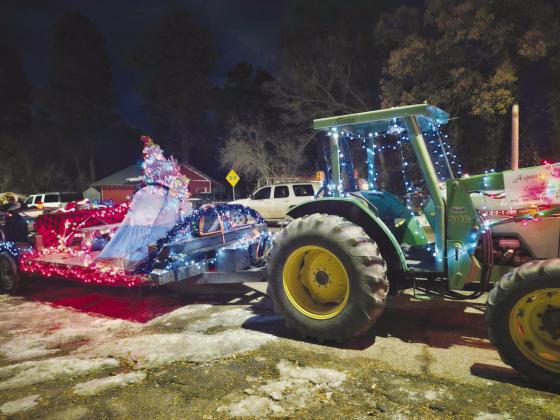 Aspen Acres Campground won First Place in the Greenhorn Valley Parade of Lights with their festive float and green John Deere Tractor. See article on p. 5. Photo by Shirley Pigg