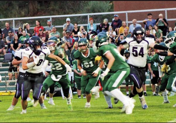 Nolan Schauer ( #8) picks up yardage against Manitou Springs behind lead blocker James Scott (#54). Courtesy Photo