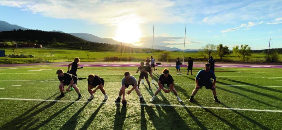 RHS Head Football Coach Connor Pigg (far right, top) observes early-season football practice. Courtesy Photo