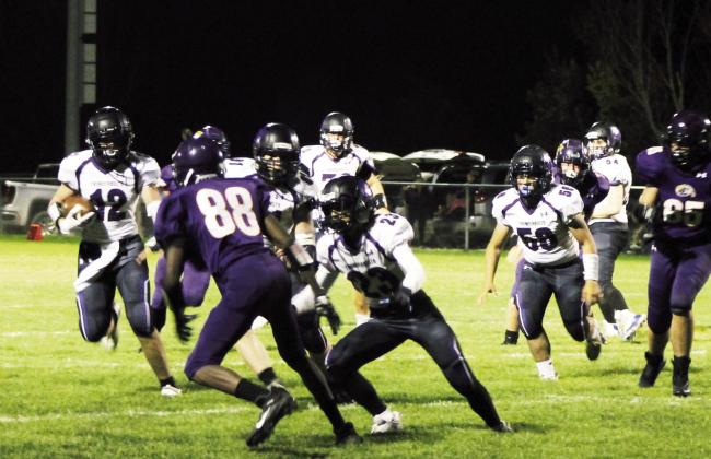 Samuel Adams #12 turns the corner around right end. Rye gained over 200 yards on the ground Friday. Photo by Karen Rochester