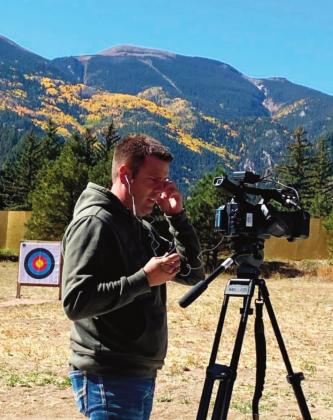 Adam Uhernik Pueblo County Information Technology Team member, setting up in Rye Mountain Park with the newly constructed archery range in the background. Photo courtesy of Bobbi Highberger
