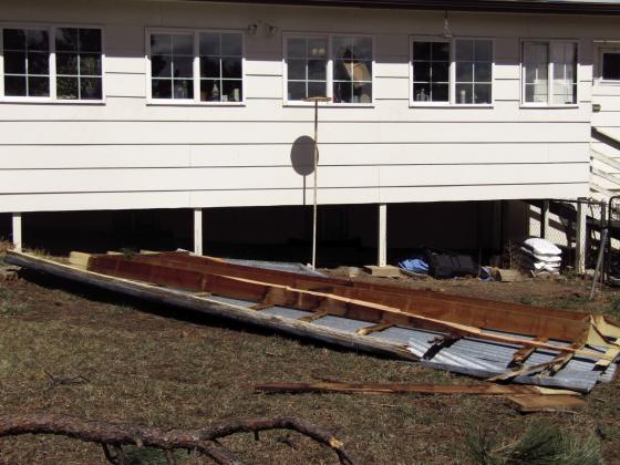 Photos show the McClure's shed with the roof peeled off and a section of the roof and tree branches that landed in the Mcclure's yard. Windows on this side of the home were broken Photos by Shirley Pigg