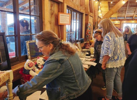 The silent auction is always a big hit with shoppers crowding to bid on the unique wares. Courtesy Photo