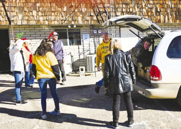 Colorado City Rye Lions and Leo Club members load a vehicle with food and toys to complete their annual Christmas drive. Courtesy Photo