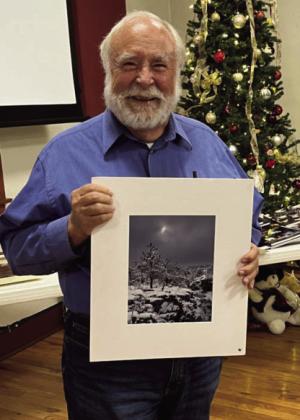 Joel Ohlsen displays one of his award-winning photos.