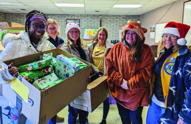 Lions Club Leos (L-R) Haley Bowler, Clara Chandler, Audry Bowler, Mylee Garner, Recipient Shawna McGinn and Lion Fran Holliday celebrate the season of giving and thank area residents who generously donated to the annual toy and food drive. Photo by Deb Straub