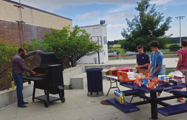 Ag teacher and FFA Advisor Ethan Beeman was everywhere at once, manning the grill, greeting students, and supervising games Photo by Shirley Pigg