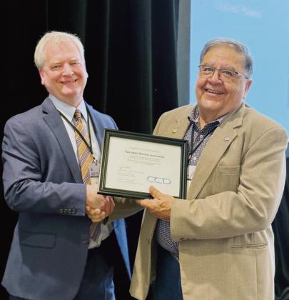 Board President Edward “Ray” Garcia accepts an award at CREA’s Annual Meeting last week. Kent Singer, Executive Director of CREA, recognized San Isabel Electric’s Board for every board member earning Credentialed Cooperative Director Certification. SIEA’s board was the only recipient in Colorado of this award. Courtesy Photo