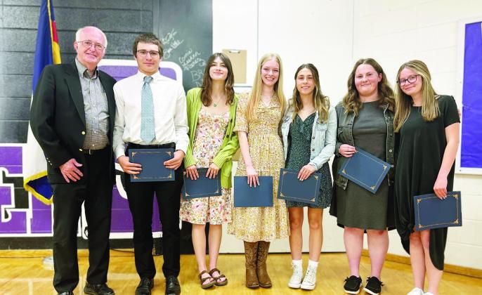 Board Member Dennis Maroney presents scholarships to students from Rye High School at SIEA’s 2023 scholarship banquet. Courtesy Photo