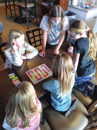 Courtesy Photo Junior Girl Scouts enjoy playing a game together.