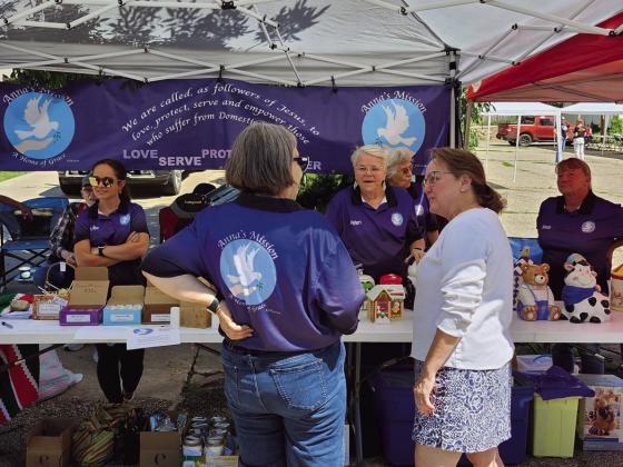 Volunteers for Anna's Mission explained their work to fairgoers at their booth during the Rye Town Square Fair. Photo by Shirley Pigg