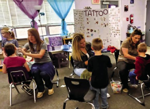 The temporary tattoo booth was a popular hit at the Rye Elementary Spring Carnival. Photo by Shirley Pigg