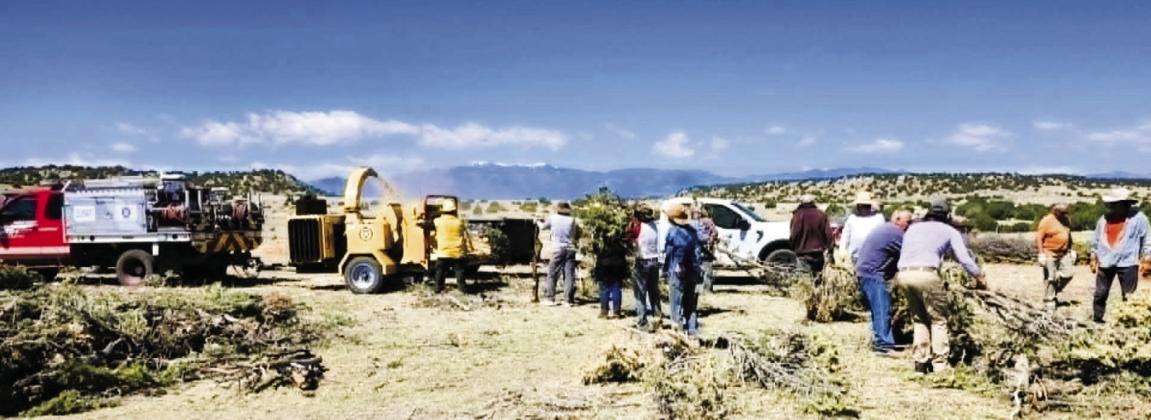Many Hatchet Ranch homeowners and FireWise volunteers turned out on Friday, May 8, to help chip the slash piles that they have cleared away from their homes.