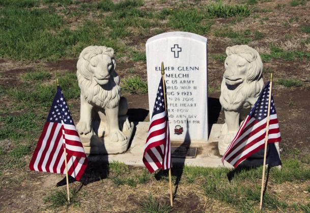 The Elmer Glenn Melchi gravesite displays three American flags, indicating three active duty, family members who served in the United States Armed Forces. Photo by Terry Kraus