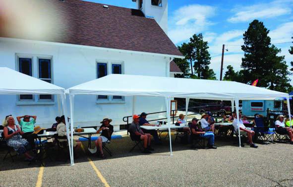 Many took advantage of the tables and chairs in the Rye Home Methodist Church parking lot to eat the delicious food from the various food trucks while listening to the musical entertainment. Photo by Shirley Pigg