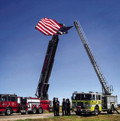 The Beulah Fire Protection Department erected a temporary arch with their fire trucks for the dedication ceremony. Courtesy Photo
