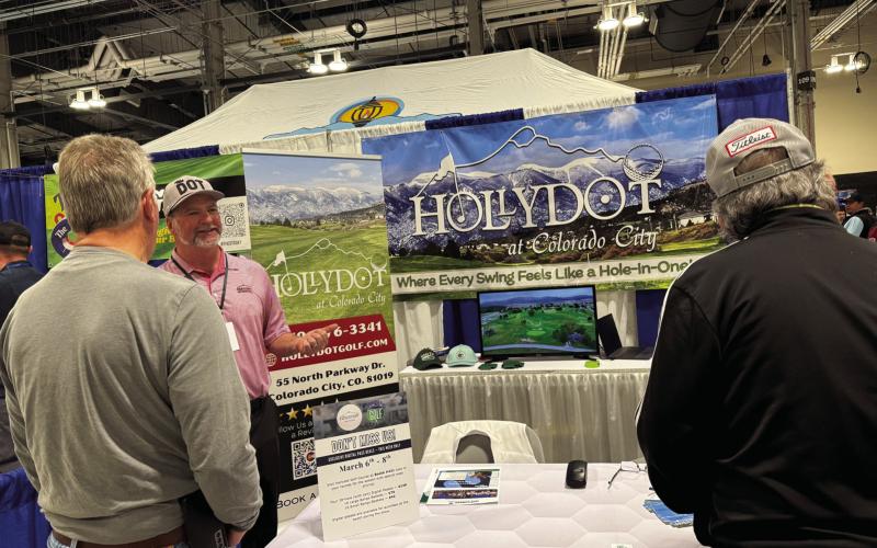 Mike Reilly (center), at the Colorado Golf Expo, acquainting golfers with the Hollydot Golf Course. Reilly started his annual trek to the event four years ago and has watched interest in Hollydot grow. Courtesy Photo