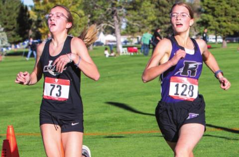 Photo by Sue Barcus Rye’s Mylee Garner finishing neck and neck with the Colts runner over the finish line at the Pueblo City/County 2021 Cross Country Championships on Wed., Oct 13. Garner finished in 25:52.20.