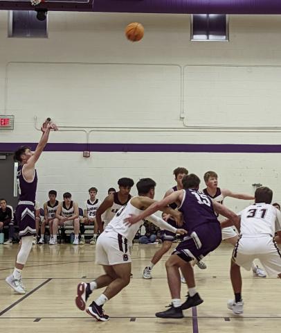 Jay Graham, #3, makes free throw shots. Graham and his teammates won their initial two games of the season. Photo by Deb Straub