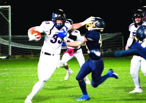 Dylan Hurne delivers a stiff-arm. Photo Courtesy of Marla Crowell