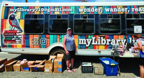 Robin Smith was all smiles as she displayed the myLibrary bookmobile at the Rye Town Square Fair. Photo by Shirley Pigg