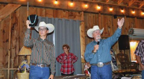 Auctioneer Jake Brunick, Cody Dodge, Cathy Hoffeld volunteer their time for the annual Mountain Aire Festival and Auction. Photo courtesy of Deb Straub