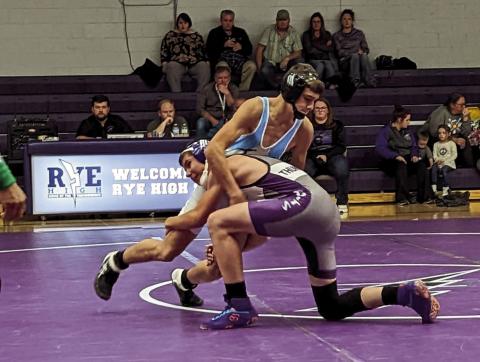 Rye High School wrestler Cody Dodge makes a move on his Trinidad opponent. Photo by Deb Straub