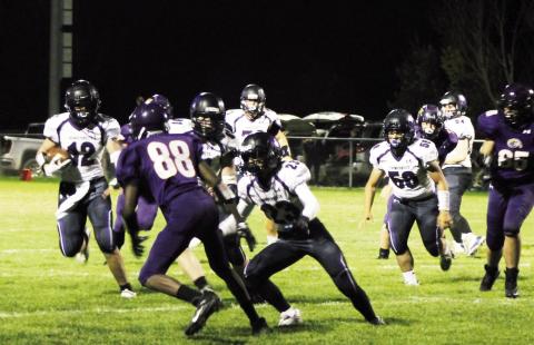 Samuel Adams #12 turns the corner around right end. Rye gained over 200 yards on the ground Friday. Photo by Karen Rochester