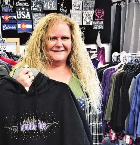 Sherri Marquez, owner of Sherri's Blings ‘n Things, displays some of her custom-designed apparel. Photo by Shirley Pigg