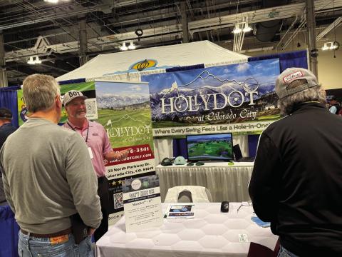 Mike Reilly (center), at the Colorado Golf Expo, acquainting golfers with the Hollydot Golf Course. Reilly started his annual trek to the event four years ago and has watched interest in Hollydot grow. Courtesy Photo